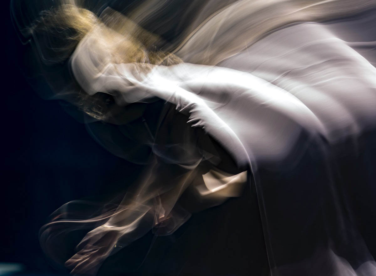 swirling image of a contemporary dancer bending forward